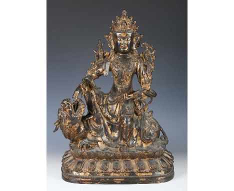 A Tibetan gilt lacquered bronze figure of Simhanada Avalokiteshvara, seated on the back of a Buddhistic lion, Ming Dynasty, 1