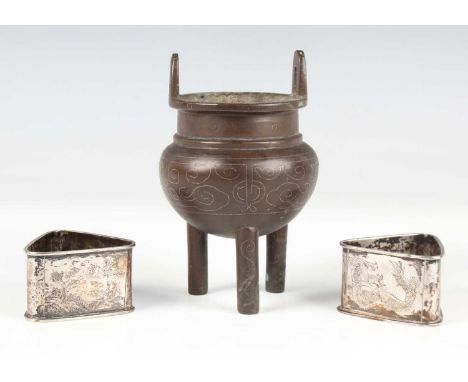 A Chinese wire inlaid brown patinated bronze tripod censer, late Qing dynasty, the globular body inlaid with a band of archai