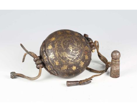 A rare Tibetan gold damascened iron gau, 14th/15th century, of circular hinged form, the top finely worked with a gold dragon