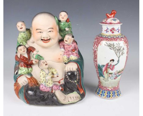 A Chinese famille rose porcelain figure of Buddha, 20th century, modelled seated and accompanied by five boys, impressed oval