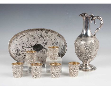 A Chinese export silver drinks set by Wang Hing &amp; Co of Hong Kong, early 20th century, comprising a spirit ewer and six s
