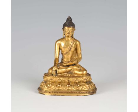 A Tibetan gilt bronze figure of Buddha, 16th century, modelled seated in dhyanasana with hands held in bhumisparsa mudra, on 