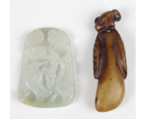A Chinese jadeite pendant, carved in relief with a bird and pine tree, length 5cm, together with a brown jade fruit pendant, 