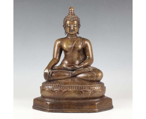 A Thai brown patinated bronze Buddha, 20th century, modelled seated in dhyanasana with hands held in bhumisparsa mudra, on a 