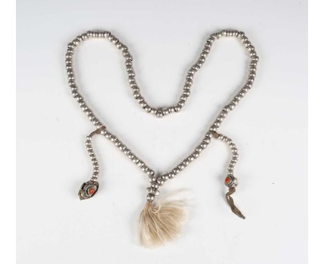 A Tibetan white metal bead mala necklace, comprising one hundred and eight flattened circular beads and a vajra marker bead, 