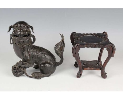 A Chinese Ming style brown patinated bronze figure of a Buddhistic lion, Qing dynasty, probably 18th century, modelled seated