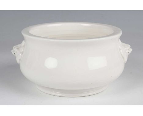 A Chinese blanc-de-Chine porcelain censer, Kangxi style but probably later, of circular bombé form with moulded lion mask han