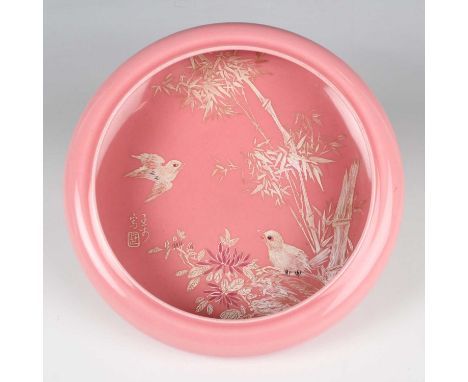 A Chinese pink glazed porcelain bowl, probably early 20th century, of shallow circular form with inverted rim, the interior e
