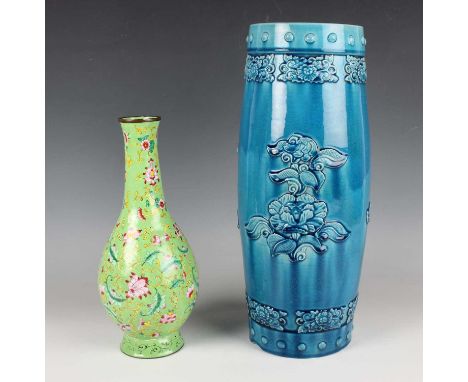 A Chinese turquoise glazed pottery vase, late Qing dynasty, of swollen cylindrical form, decorated in relief with flower spra