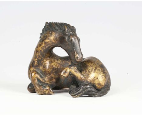 A Chinese bronze scroll weight, Ming dynasty, finely modelled as a recumbent horse with detailed mane and tail, height 5.4cm,