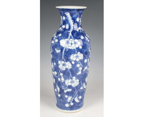 A Chinese blue and white porcelain vase, mark of Kangxi but late 19th century, of shouldered tapering form, painted with blos