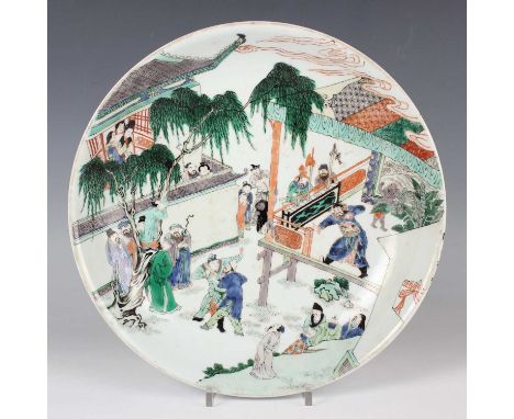 A Chinese famille verte porcelain circular dish, Kangxi style but later, the interior painted with a figural scene, underglaz