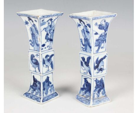 A pair of Chinese blue and white export porcelain beaker vases, Kangxi period, of square section trumpet form, each side pain