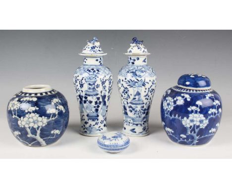 A pair of Chinese blue and white porcelain vases and covers, mark of Kangxi but late 19th century, of baluster form, each pai