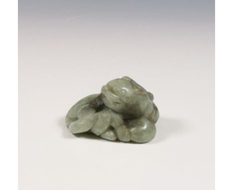 China, a mottled green jade 'bixie' carving, Ming dynasty (1368-1644), the mythological animal carved in reclining position s