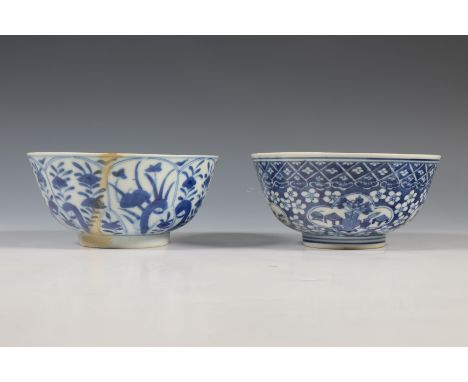 China, two blue and white porcelain bowls, 19th century, one painted with cartouches enclosing antiquities on a prunus and cr