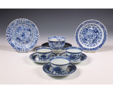 China, two sets of blue and white porcelain cups and saucers, 19th century, comprising a set of three cups and saucers painte