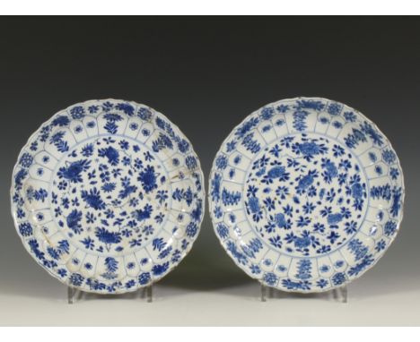 China, a pair of blue and white porcelain plates, Kangxi period (1662-1722), each moulded with petal-shaped panels and decora