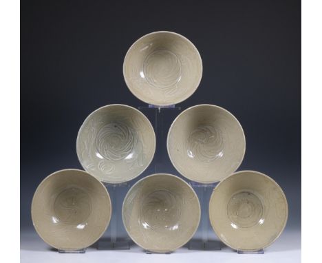 China, a collection of six celadon-glazed bowls, Song dynasty, 10th-12th century, each with incised flowing and combed decora