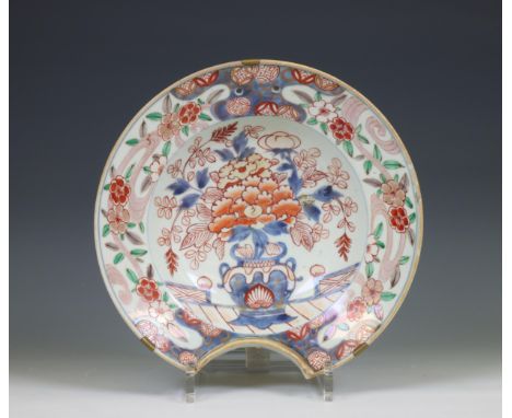 Japan, an Imari porcelain shaving basin, 19th century, painted with a peony in a flower-pot, pierced for hanging (rim chips, 