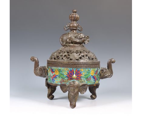 China, a bronze tripod censer and cover, 20th century, resting on elephant-head feet, the sides with elephant-head handles an