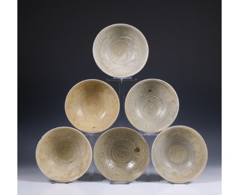 China, a collection of six celadon-glazed bowls, Song dynasty, 10th-12th century, each with incised flowing and combed decora