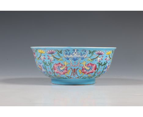 China, a blue-ground famille rose bowl, modern, decorated with shou-characters and stylised bats among lotus-scroll on a sky-