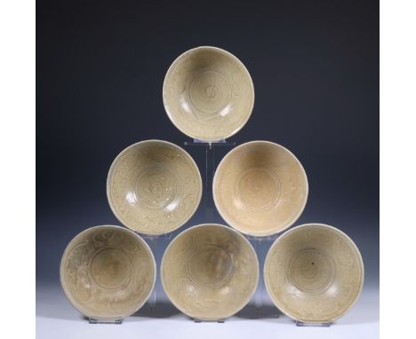 China, a collection of twelve celadon-glazed bowls, Song dynasty, 10th-12th century, each with incised flowing decoration and
