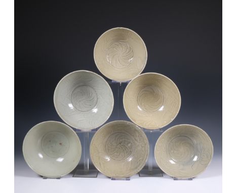China, collection of six celadon-glazed bowls, Northern Song dynasty, 10th-12th century, each with incised floral decoration,