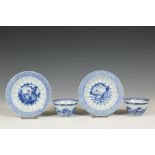 China, a pair of blue and white Kangxi-style 'acupuncturist' cups and saucers,