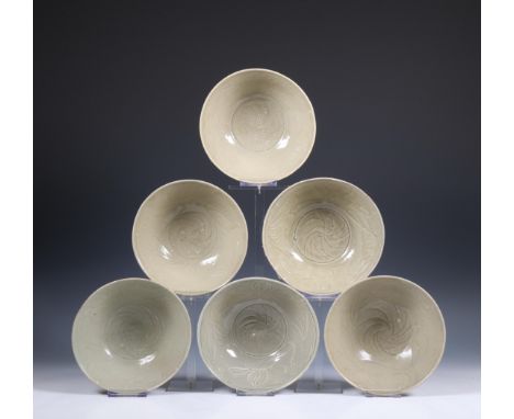 China, a collection of six celadon-glazed bowls, Song dynasty, 10th-12th century, each with incised flowing and combed decora