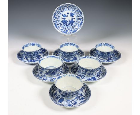 China, two sets of blue and white porcelain cups and saucers, 18th century, comprising a set of three cups and saucers painte