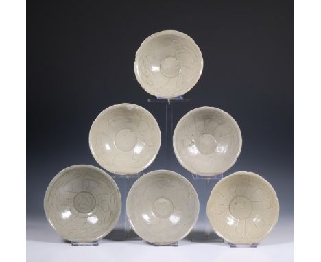 China, a collection of twelve celadon-glazed bowls, Song dynasty, 10th-12th century, each with incised flowing decoration, co