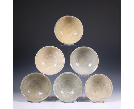 China, a collection of six celadon-glazed bowls, Song dynasty, 10th-12th century, each with incised flowing decoration, the e