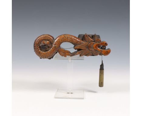 Japan, a wooden writing tool, ca. 1900, carved as a dragon and used for line drawing with wheel and string (wear) l. 18 cm [1