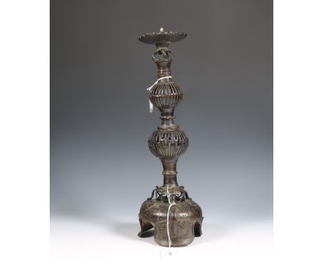 Korea, a bronze candlestick, Joseon dynasty (1392-1910), on wide tripod base and with openworked holder ( broken into two pie