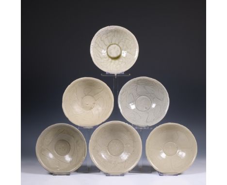 China, a collection of twelve celadon-glazed bowls, Song dynasty, 10th-12th century, each with incised flowing decoration, co