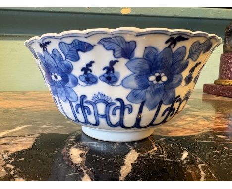 China, a blue and white porcelain bowl, 19th century, the sides moulded as rows of petals and decorated with flowers, the int