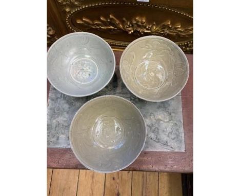 China, a collection of six celadon-glazed bowls, Song dynasty, 10th-12th century, each with incised flowing and combed decora