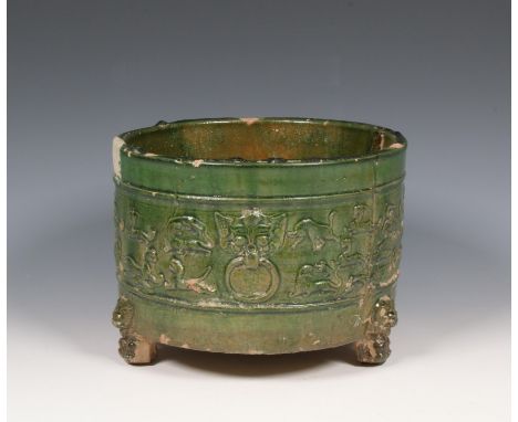 China, a green-glazed pottery tripod censer, Han dynasty (206 BC- 220 AD), the sides moulded in relief with a band of mythica