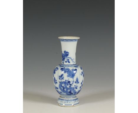China, a small blue and white porcelain vase, Kangxi period (1662-1722), painted with panels of flowers (some damage and repa