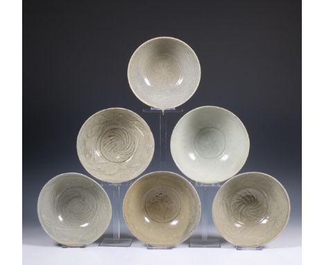 China, a collection of six celadon-glazed bowls, Song dynasty, 10th-12th century, each with incised flowing decoration, cover