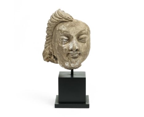 India, Gupta, a stucco fragment of a female head, 4th-6th century h. 9,5 cm. Provenance: Paul Rutten Asiatic & Tribal Art, Am