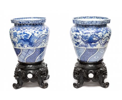 Japan, a pair of large blue and white porcelain jardinières on ebonised stands, Edo/Meiji period, 19th century, each decorate