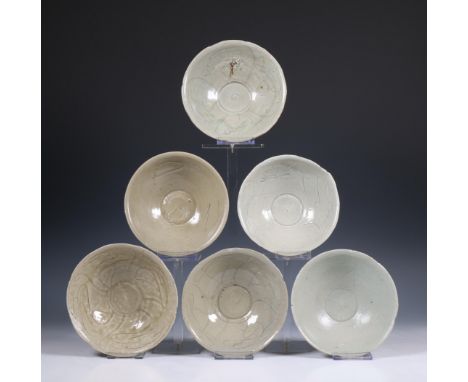 China, a collection of twelve celadon-glazed bowls, Song dynasty, 10th-12th century, each with incised flowing decoration, co