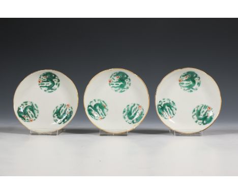China, a set of three famille verte 'dragon' saucers, 19th century, each decorated with three dragon roundels, the reverse wi