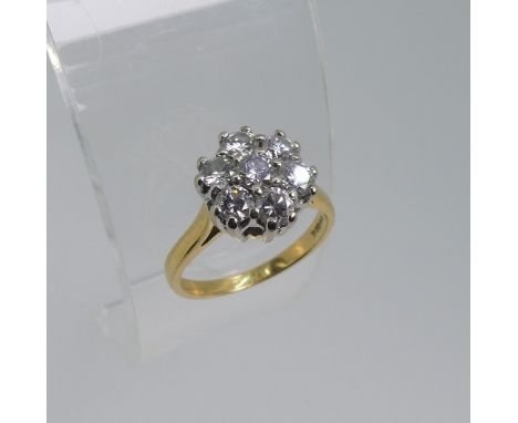 A diamond flowerhead cluster Ring, the central brilliant cut stone approx. 0.18ct with six further brilliant cut stones aroun