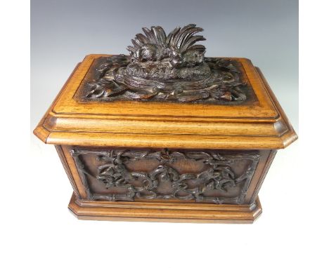 A late 19thC Black Forest carved and stained Tea Caddy, of rectangular form, the hinged lid carved with hares amongst grass o
