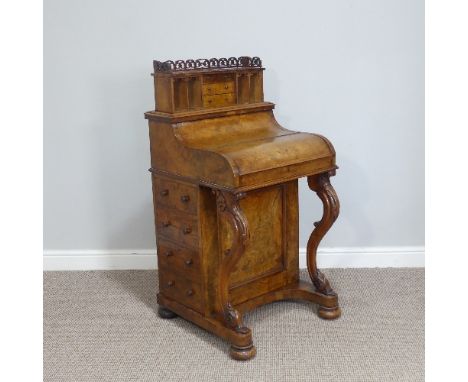 A 19thC walnut pop-top Davenport, the galleried top enclosing a pop-up section with drawers and pigeonholes above a sloping f
