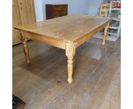 A pine farmhouse Kitchen Table, with rounded corners, on turned legs, some mouse damage to one leg, W 215cm x D 120cm x H 77c